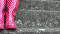 4K Panning in on a staircase where a woman is standing in red wellies with dots 4k or 4k+ Resolution