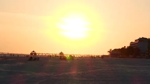 4K Panning Sunset Beach Scene Children Playing  Near Pier Stock Footage 155409881