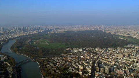 4K Panoramic aerial view of Paris skyline with River Seine &amp; large park area Stock Footage 77146191