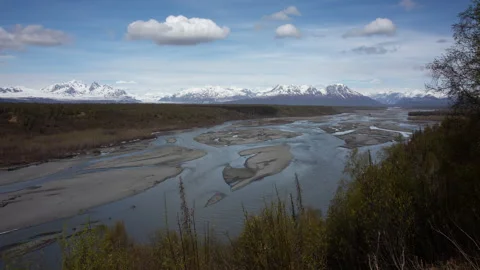 4K panoramic time lapse of low clouds hiding the snowy peak of Denali in Alaska Stock Footage 242884404