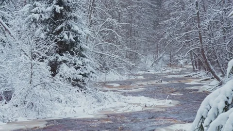 4k, A panoramic view of the brown Roshchinka River, partially covered with ice Video stock 326558265
