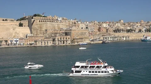 4K Panoramic view Valletta old town by day touristic boat sailing Malta landmark Stock Footage 90326545