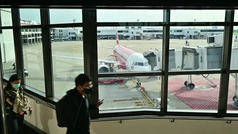 4K Passenger at the boarding gate walking to Thai Air Asia airplane Stock Footage 136818391