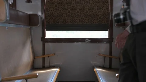 4K passenger making himself comfortable in train car checking his camera Stock Footage 90806400