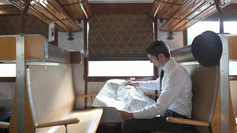 4K passenger making himself comfortable in train car checking his map Stock Footage 90808274