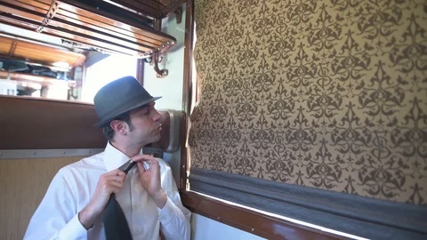 4K passenger making himself comfortable with vintage drapes in the background Stock Footage 90813296