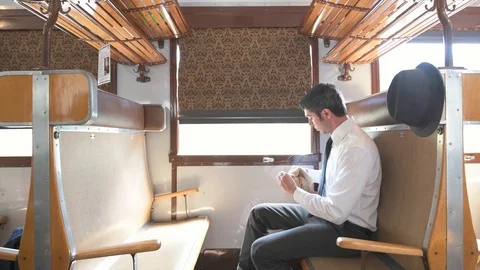4K passenger in old vintage train cleaning his glasses Stock Footage 90807737
