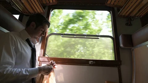 4K passenger in old vintage train cleaning his glasses Stock Footage 90808904