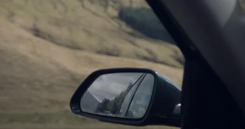4K Passenger Side view Mirror in The Glen Coe Scottish Mountains. Car travelling Stock Footage 93049749