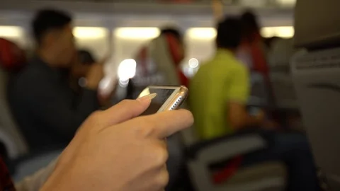 4K Passenger using device phone in flight. People travelers check smartphone-Dan Stock Footage 89014540