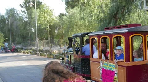 4k Passing Miniature Train WIth Pan, Disneyland Style in Park Stock Footage 53411730