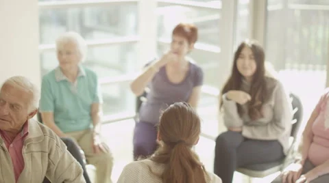4K People in group therapy session share a light hearted moment &amp; laugh together Stock Footage 44635512