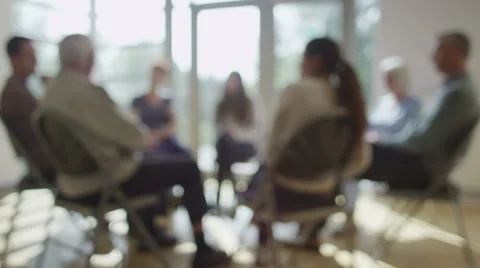 4K People in group therapy session talk about their problems in sunlit room Stock Footage