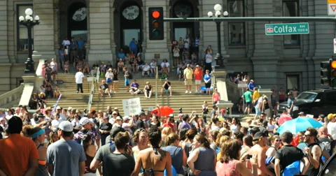4K People marching with Rainbow flags Gay Pride Parade Colfax Denver Stock Footage 65502651