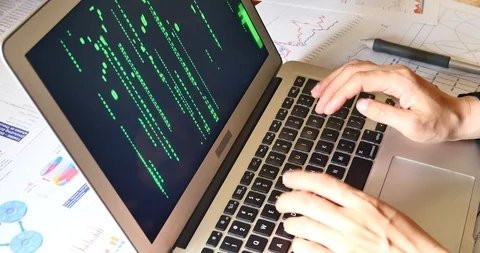 4k people operating computer,The Matrix style binary code on laptop. 库存影片 88984727