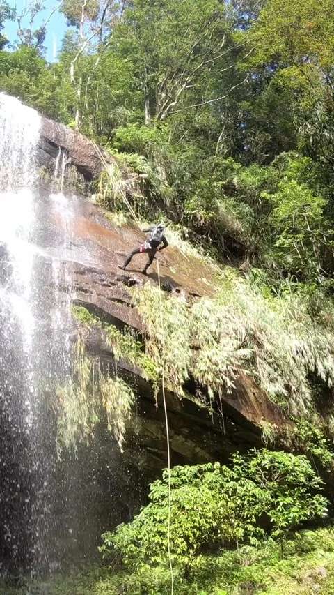 4K People practice rappelling, passing through waterfall canyon and riverbed Stock Footage 314818139