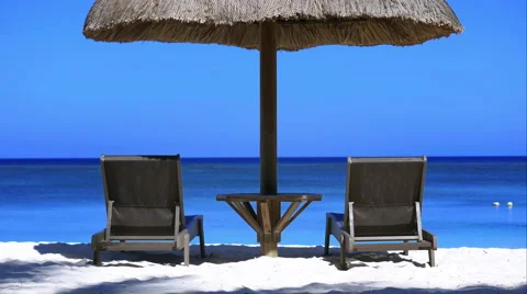 4K Perfect holidays view : 2 deckchairs and an umbrella with ocean view Stock Footage 57782407