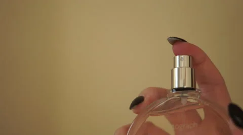 4K Perfume sprayed from clear bottle by womans hand Stock Footage 59799896