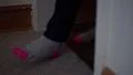 4K Person with beige and pink socks is walking through a door frame indoors 4k or 4k+ Resolution