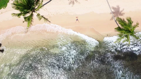 4K person lying stretched out on exotic sunny beach making star shape resting an 動画素材 244837693