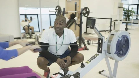 4K Personal trainer watching over clients, working out in modern gym Stock Footage 75846904