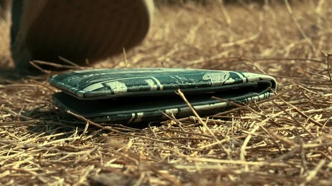 4K Picking up wallet from the ground Stock Footage 127654768