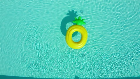 4K Pineapple ring tube floating on the hotel turquoise rippled waves. Stock Footage 162892738
