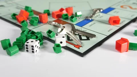 4K plastic red and green coloured toy houses with a set of door keys on a game Stock Footage 90799234