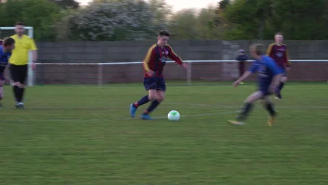 4K: Player dribbles withe the ball in a men's Soccer / Football match. Stock Footage 154457568