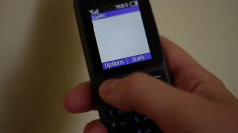 4K Playing around with old school mobile phone, writing numbers, message, menus Stockbeeldmateriaal 52180302
