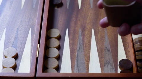 4K playing backgammon using a wooden set, rolling brown dice Stock Footage 50376131