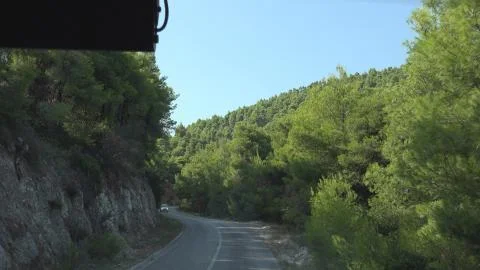 4K Point of view car driving mountain road dangerous street travel sunny day Stock Photos