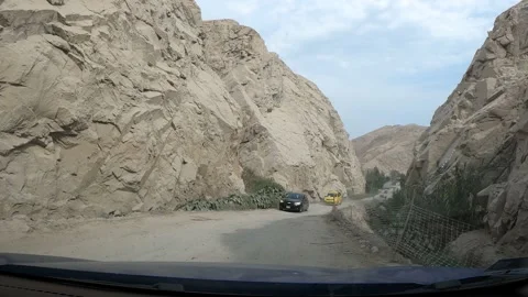 4k point of view going through a very narrow road between mountains with a car Stock Footage 144354912