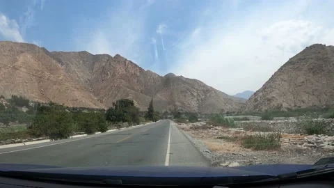 4k point of view starting to move a car on a road between mountains and vegetati 스톡 동영상 144357139