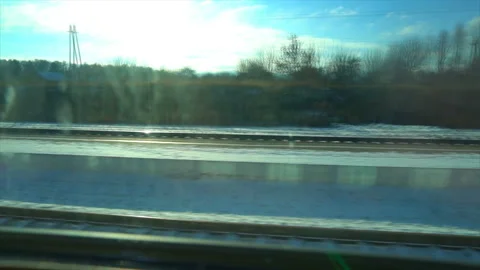 4K Point of view from the window of a passenger train. The deserted winter Stock Footage 99423619