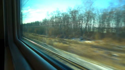 4K Point of view from the window of a passenger train. The deserted winter Stock-Footage 99428428