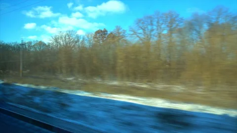 4K Point of view from the window of a passenger train. The deserted winter Stock Footage 99428693
