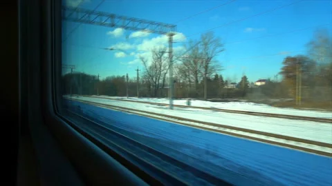 4K Point of view from the window of a passenger train. The deserted winter Stock Footage 99428892