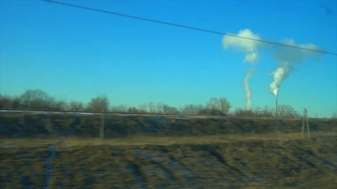 4K Point of view from the window of a passenger train. The working factory moves Stock Footage 99431821