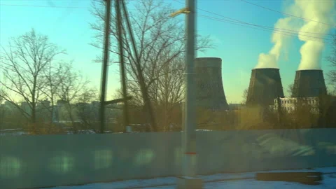 4K Point of view from the window of a passenger train. The nuclear power plant Stock Footage 99432295