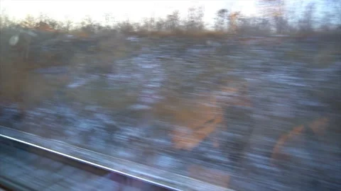 4K Point of view from the window of a passenger train. The deserted winter Stock Footage 99434853
