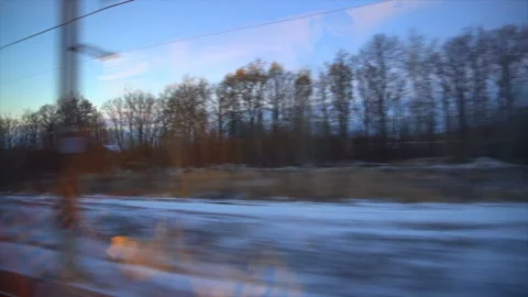 4K Point of view from the window of a passenger train. The deserted winter Stock Footage 99435128