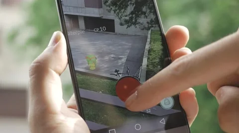 4K Pokemon Go Playing on Smartphone Screen Outdoors - Augmented reality Stock Footage