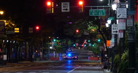 4K POLICE CRUISER BLOCKING EMPTY ROAD DURING CURFEW Stock Footage 132602901