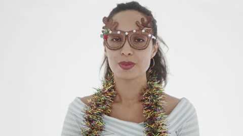 4K portrait of appealing young dark-haired woman in white top with garland on Stock Footage 137664145