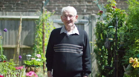 4K Portrait of cheerful elderly man standing in the garden at home. Stock Footage 63279577