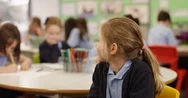 4K Portrait Cute Smiling Little Girl In Primary School Classroom Stock Footage
