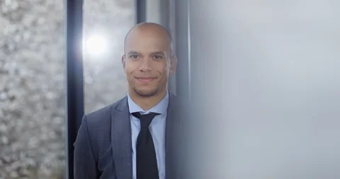 4K Portrait of handsome businessman looking directly at camera &amp; smiling Stock Footage 101410053