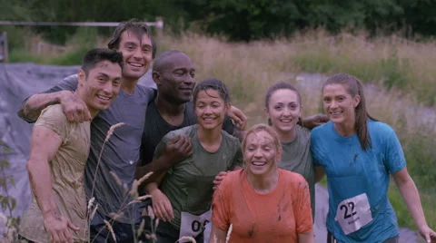 4K Portrait happy smiling mud race runners at end of race Stock Footage 65796432