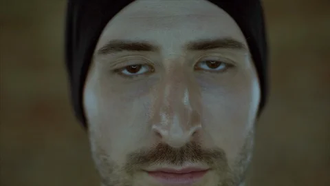 4K The portrait of the man in hat with three day beard blink in teh camera Stock-Footage 102862555